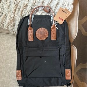 Backpack-black with brown leather holder.